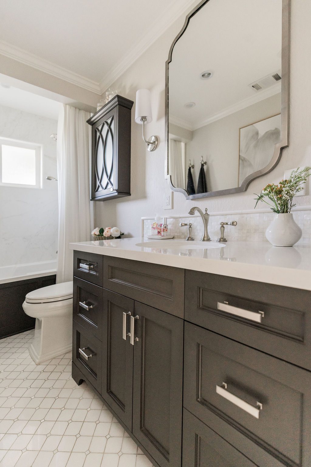 Spa-inspired bathroom renovation included in a whole house remodel checklist, featuring neutral tile and modern fixtures.